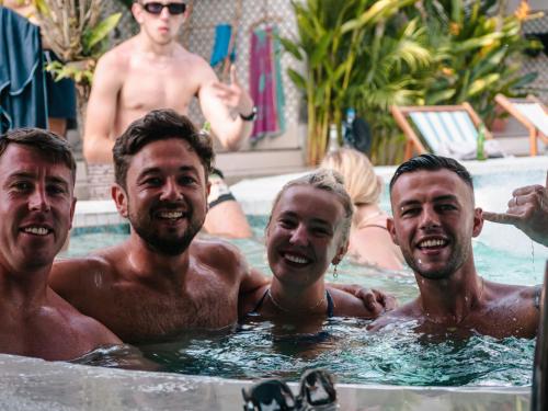 a group of men in a swimming pool at Clandestino Hostel Canggu in Canggu