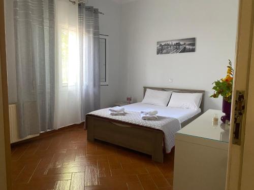 a small bedroom with a bed and a window at Klarida house in Kirás Vrísi