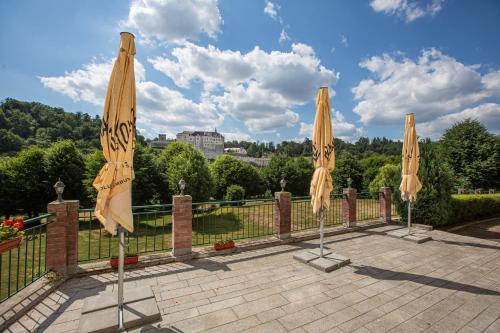 a group of umbrellas sitting on a patio at Pension v parku Český Šternberk in Český Šternberk