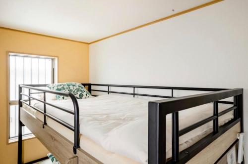 a black bunk bed in a room with a window at Private lodging in WEST TOKYO(SHINJUKU, TACHIKAWA, SANRIO, GHIBLI, MT. TAKAO etc) in Kokubunji