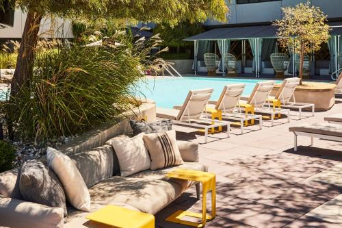 a couch and chairs next to a swimming pool at Kimpton Sawyer Hotel by IHG in Sacramento