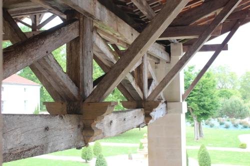 a view of a wooden building with wooden beams at Domaine des Chais in Thénac