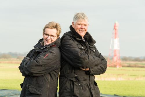 two people standing next to each other in a field at FEWO Morgenröte - Weserblick -Harriersand in Schwanewede