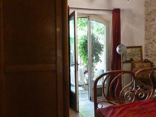 a dining room with a door leading to a patio at Chambre d'hôtes in Lançon-Provence