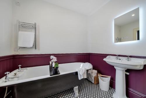 a bathroom with a sink and a bath tub and a toilet at Seaview Lodge Apartment 'Sleeping 4 Guests' in Tieveborne