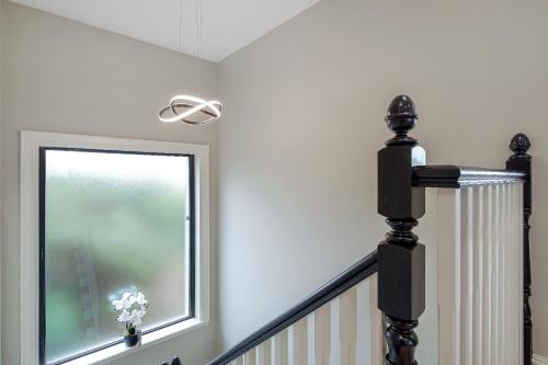 a stairwell with a window and a stair railing at Seaview Lodge Apartment 'Sleeping 4 Guests' in Tieveborne