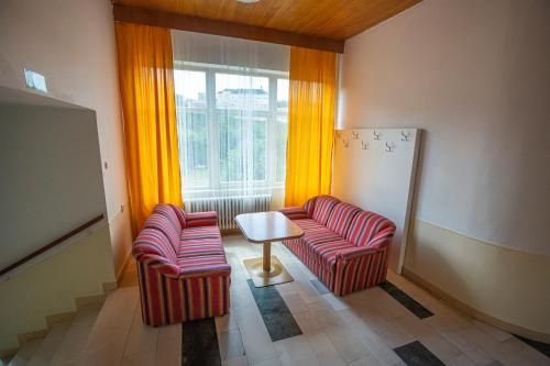 a room with two chairs and a table and a window at Pension v parku Český Šternberk in Český Šternberk