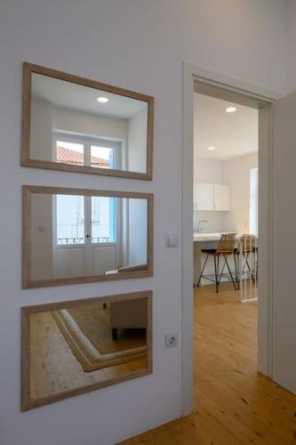 a living room with two mirrors on a wall at Katina's Coastal Oasis in Pylos