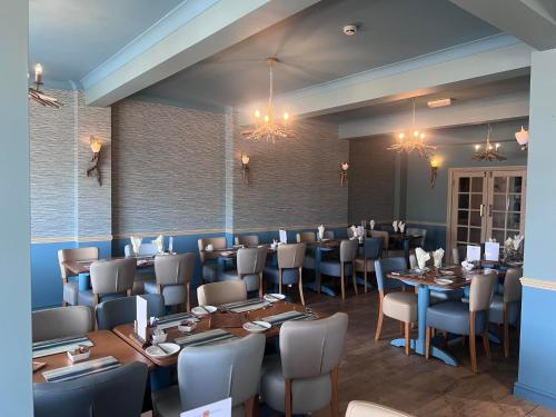 a restaurant with tables and chairs in a room at The Savoy in Skegness