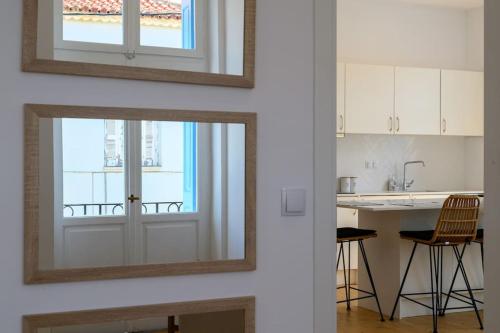 a kitchen with a mirror and a sink and a counter at Katina's Coastal Oasis in Pylos