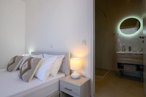 a bedroom with a bed with a lamp and a sink at Katina's Coastal Oasis in Pylos