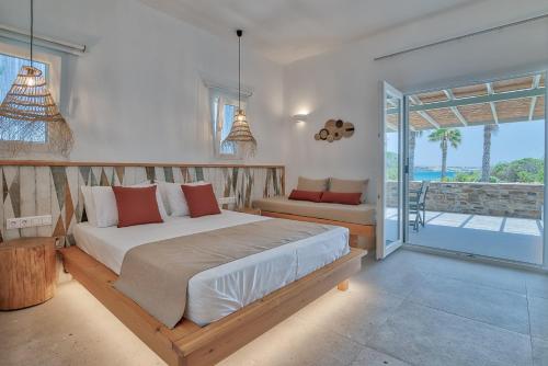 a bedroom with a large bed and a balcony at Marinatou Suites in Antiparos Town