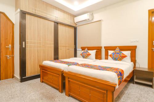 a bedroom with a large wooden bed in a room at FabExpress RS Living - Nr TCS Deccan Park, Hitech City in Hyderabad