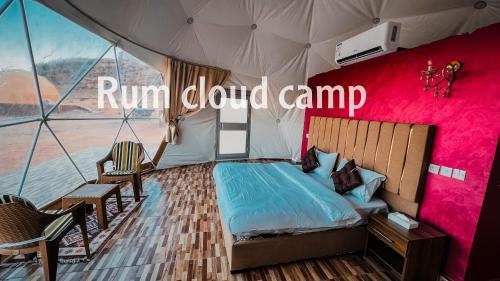 a bedroom in a tent with a bed and chairs at Rum cloud camp in Wadi Rum