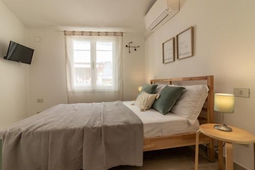 a bedroom with a large bed with a window at WanderJohn penthouse 5terreparco in Riomaggiore