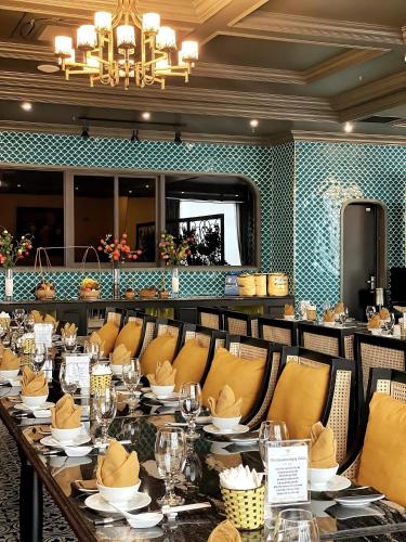a dining room with a long table and chairs at MADELISE HOTEL&APARTMENT in Hai Phong