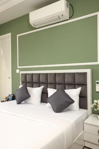 a bedroom with a large bed with white pillows at White Mint in Yercaud
