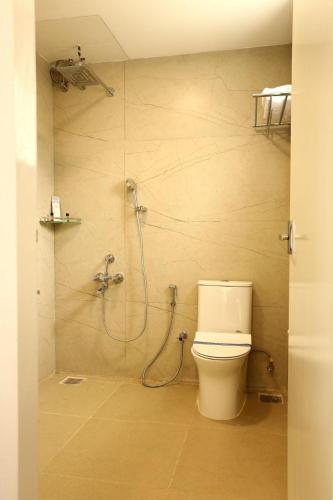 a bathroom with a toilet and a shower at White Mint in Yercaud