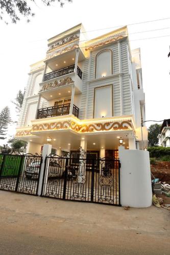 a large white building with a gate in front of it at White Mint in Yercaud