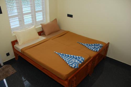 a bed with two pillows on it in a room at Countryside inn in Tiruvankod