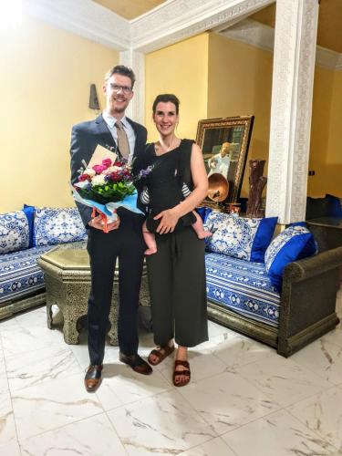 a man and a woman standing next to a couch at Riad Malak in Meknès