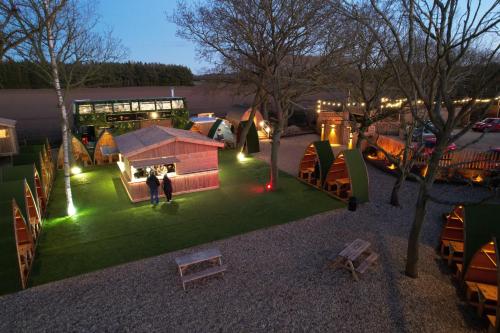 an overhead view of a park with tents and a building at Woodlakes Park By Liv Retreats in Kings Lynn