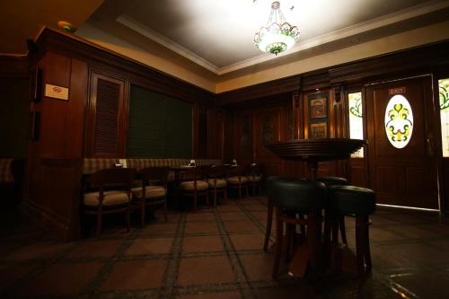 a dining room with tables and chairs and a chandelier at Park Plaza Jodhpur in Jodhpur