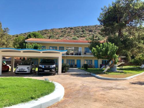 a house with cars parked in front of it at Bouros Seaview Farm in Karistos