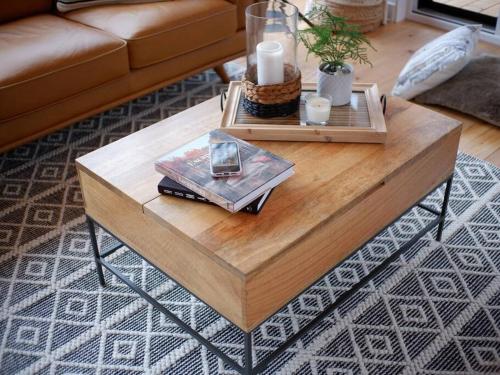 a wooden coffee table in a living room at trähus tremblant in La Conception