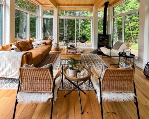 a living room with a couch and chairs at trähus tremblant in La Conception