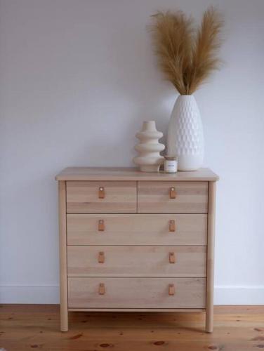 a dresser with a vase on top of it at trähus tremblant in La Conception