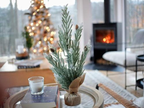a living room with a christmas tree and a table with a glass of wine at trähus tremblant in La Conception