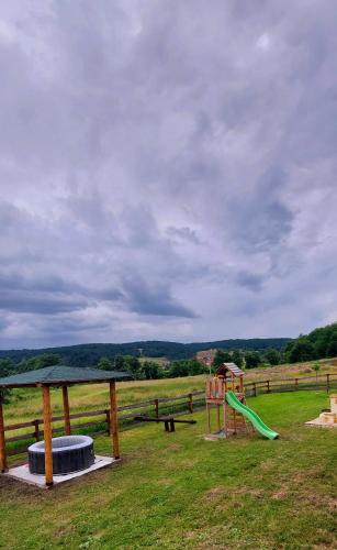 a park with a playground with a slide at Planinska kuća Isiteo in Kremna