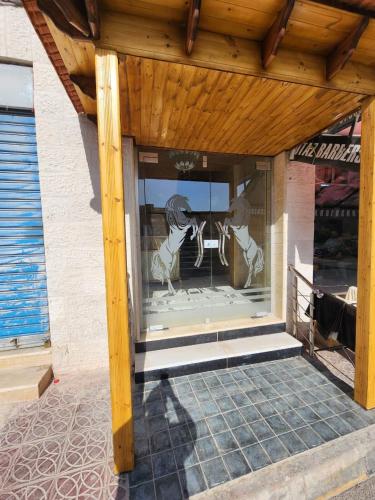 a store front with a window with two people in it at Dream house hotel jerash in Jerash