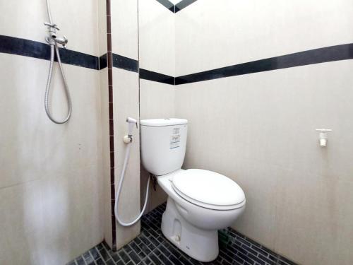 a bathroom with a toilet and a shower at Griya Juanda Syariah near RS Dharma Husada Probolinggo Mitra RedDoorz in Sukobumi