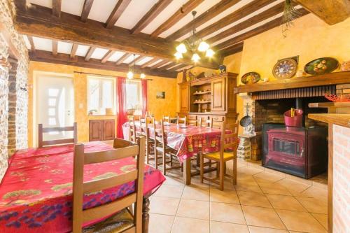 une salle à manger avec une table et une cheminée dans l'établissement La Glycine et La Villanelle, 