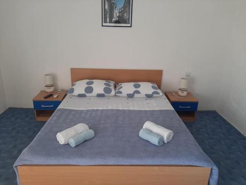 um quarto com uma cama com duas almofadas em Kuća za odmor u blizini Splita em Jesenice