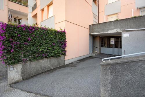 a building with purple flowers on the side of it at Casa Cogoleto terrace and parking in Cogoleto