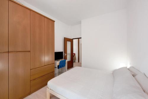 a bedroom with a bed and a cabinet and a television at Casa Cogoleto terrace and parking in Cogoleto
