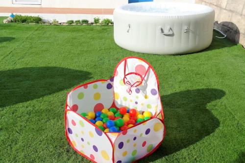 a box full of balls sitting on the grass at Hakuna Matata in Cano
