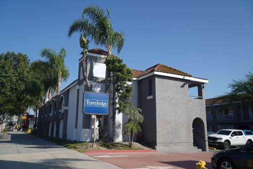 a blue sign in front of a building at Travelodge by Wyndham Whittier in Whittier