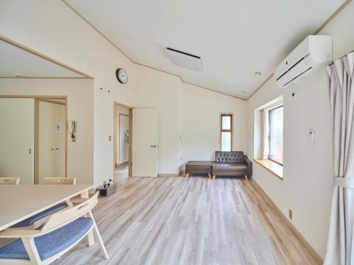 a living room with a couch and a table at Villa Miura Beach -ヴィラ三浦海岸- in Miura