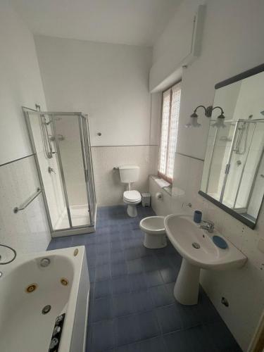 a bathroom with two sinks and a shower and a toilet at Villa Remignoli in San Gimignano