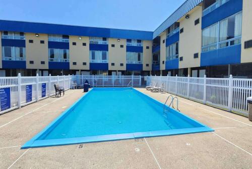 an empty swimming pool in front of a building at Days Inn by Wyndham Fort Wright Cincinnati Area in Fort Wright