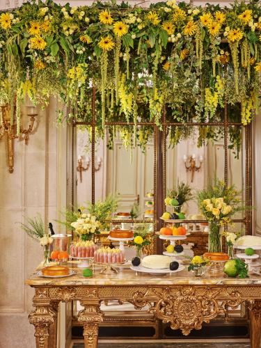a table with flowers on top of it at Le Meurice – Dorchester Collection in Paris
