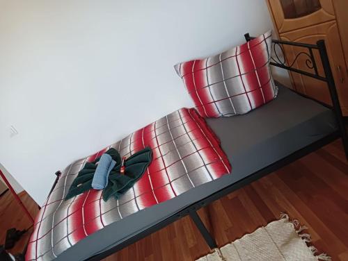 a bunk bed with two red pillows on it at Stella s Monteurswohnungen in Werdau