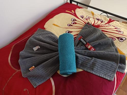 a blue towel on top of a bed at Stella s Monteurswohnungen in Werdau