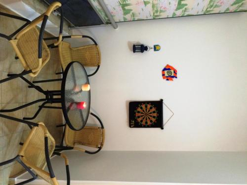 a room with a wall with a dart board and a shelf at Golem Apartments in Golem