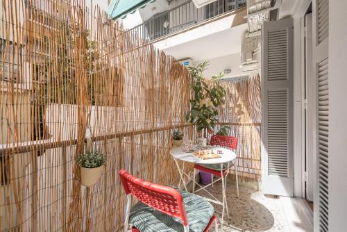 a small balcony with a table and chairs at Sweet home in Koukaki in Athens
