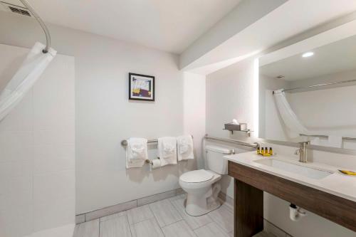 a white bathroom with a toilet and a sink at Best Western Plus Harrisonburg in Harrisonburg